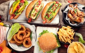 The ultimate American food — a juicy beef patty served in a bun with cheese, lettuce, tomato, onions, and sauces. Each region has its twist (smash burgers, gourmet, BBQ-style).